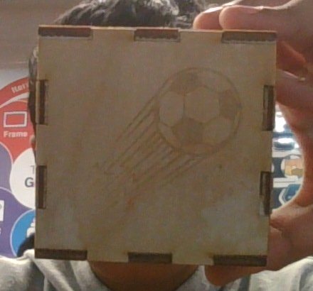Cube face engraved with a soccer ball